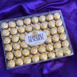 Box of Ferrero Rocher chocolates on purple fabric