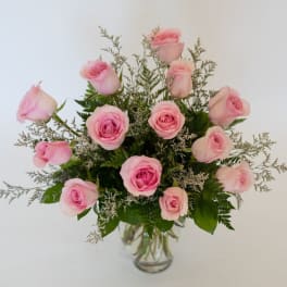Pink roses arranged in a clear glass vase