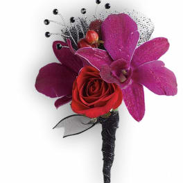 Red rose boutonniere with purple orchid petals and black accents