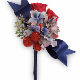 Red roses and blue hydrangeas with navy ribbon wrap