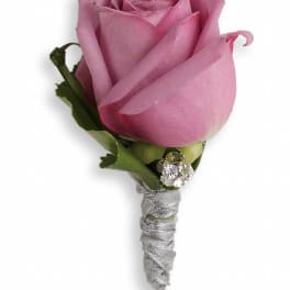 Pink rose boutonniere with silver ribbon and rhinestone accent