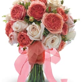 Bouquet of pink and white roses tied with a pink ribbon