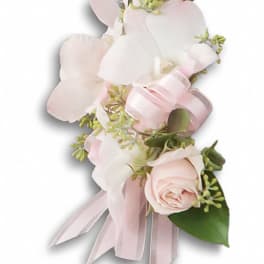 Pink and white floral corsage with ribbon