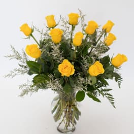 Yellow roses arranged in a clear glass vase