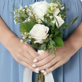 White rose bouquet with greenery and a white ribbon