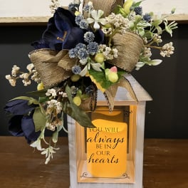 Floral memorial lantern with navy flowers and a sympathy message