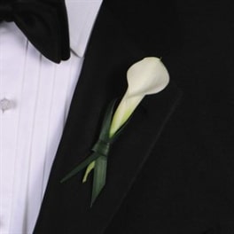 White calla lily boutonniere on a black suit jacket