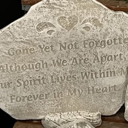 Decorative stone plaque with a heart and engraved quote