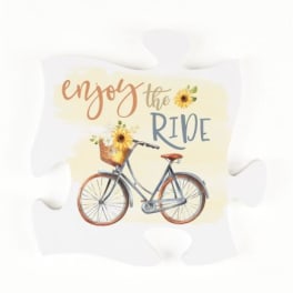 Decorative pillow with a bicycle and sunflower graphic and the words enjoy the ride