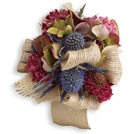 Bouquet of burgundy and pink flowers wrapped in burlap