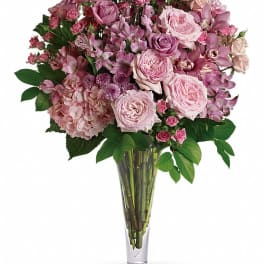 Pink mixed flower bouquet in a clear glass vase