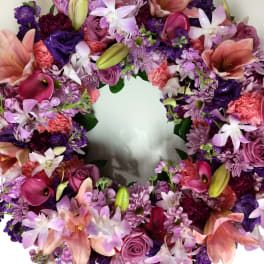 Heart-shaped floral wreath with pink, purple, and white blooms