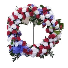 Circular floral wreath with red, white, and blue flowers