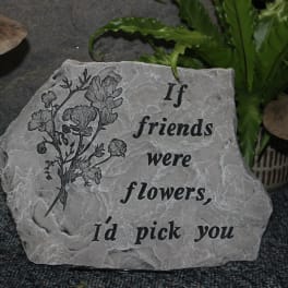 Engraved stone plaque with a flower illustration and friendship quote
