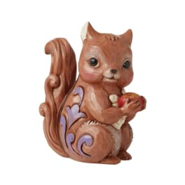 Decorative squirrel figurine holding an apple