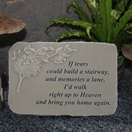 Memorial plaque with a sympathy quote between two mushroom ornaments