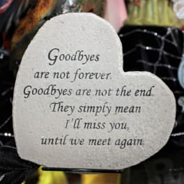 Heart-shaped memorial stone with a goodbye quote