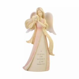 Angel figurine holding a heart with the word Love