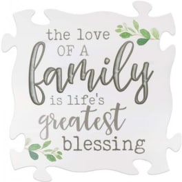 Decorative puzzle-piece sign with the words "the love of a family is life's greatest blessing"