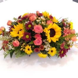 Mixed bouquet with sunflowers, pink roses, and burgundy daisies