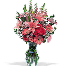 Pink and red mixed flower bouquet in a clear glass vase