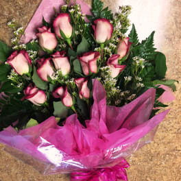 Bouquet of pink roses wrapped in bright pink paper