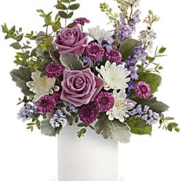 Lavender roses and purple-white flowers in a white vase
