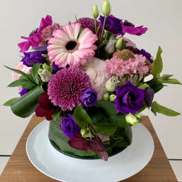 Pink and purple mixed bouquet in a glass vase