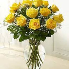 Yellow roses arranged in a clear glass vase