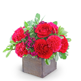 Red roses and pink carnations in a wooden box