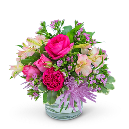Pink roses and lilies in a clear glass vase