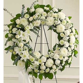 Large white floral wreath on a black easel