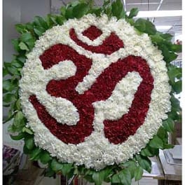 Round floral wreath with red and white flowers and green leaves