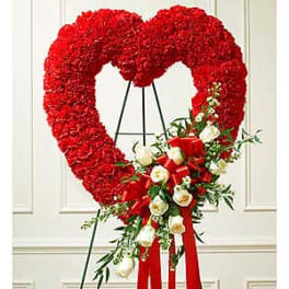 Heart-shaped red floral standing spray with white roses and ribbon