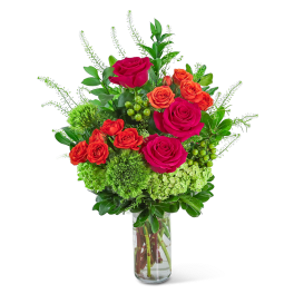 Bouquet of pink and orange roses in a clear glass vase