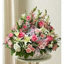 Large basket arrangement of pink roses and white lilies