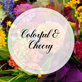 Colorful mixed flower bouquet with a round label reading "Colorful & Cheery"