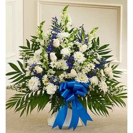 Large white and blue floral spray with a blue ribbon