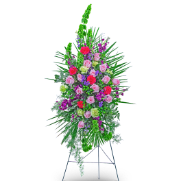 Standing floral spray with pink roses and bright mixed flowers on an easel