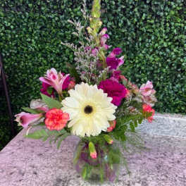 Mixed pink and white flowers in a glass vase