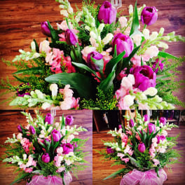 Bouquets of purple tulips and pink snapdragons with greenery