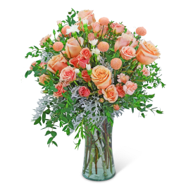 Peach and pink rose bouquet in a clear glass vase