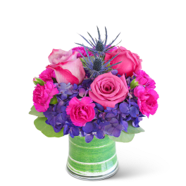 Pink roses and purple flowers in a green striped vase
