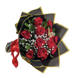 Bouquet of red roses wrapped in black paper with gold trim
