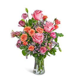 Pink and orange roses in a clear glass vase