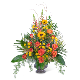 Tall arrangement of orange roses and yellow sunflowers in a gray vase