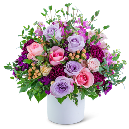 Bouquet of pink and lavender roses in a white vase