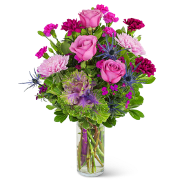 Pink roses and purple flowers in a clear glass vase