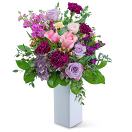 Mixed pink and lavender bouquet in a white vase