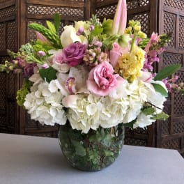 Pink and white mixed flower arrangement in a glass vase